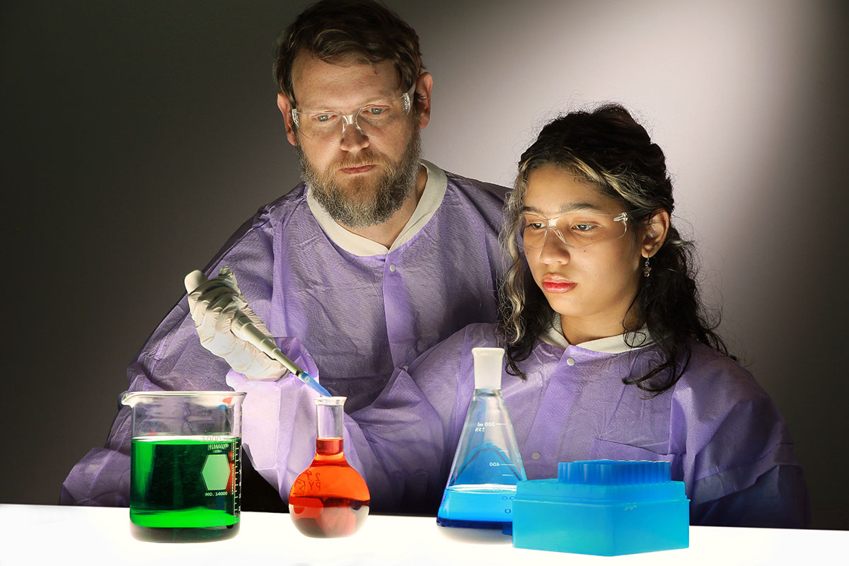 Professor and students working in lab