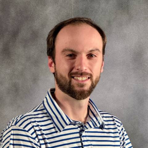 Male with beard and striped polo shirt