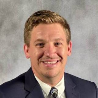 Male in blue sports coat and plaid tie