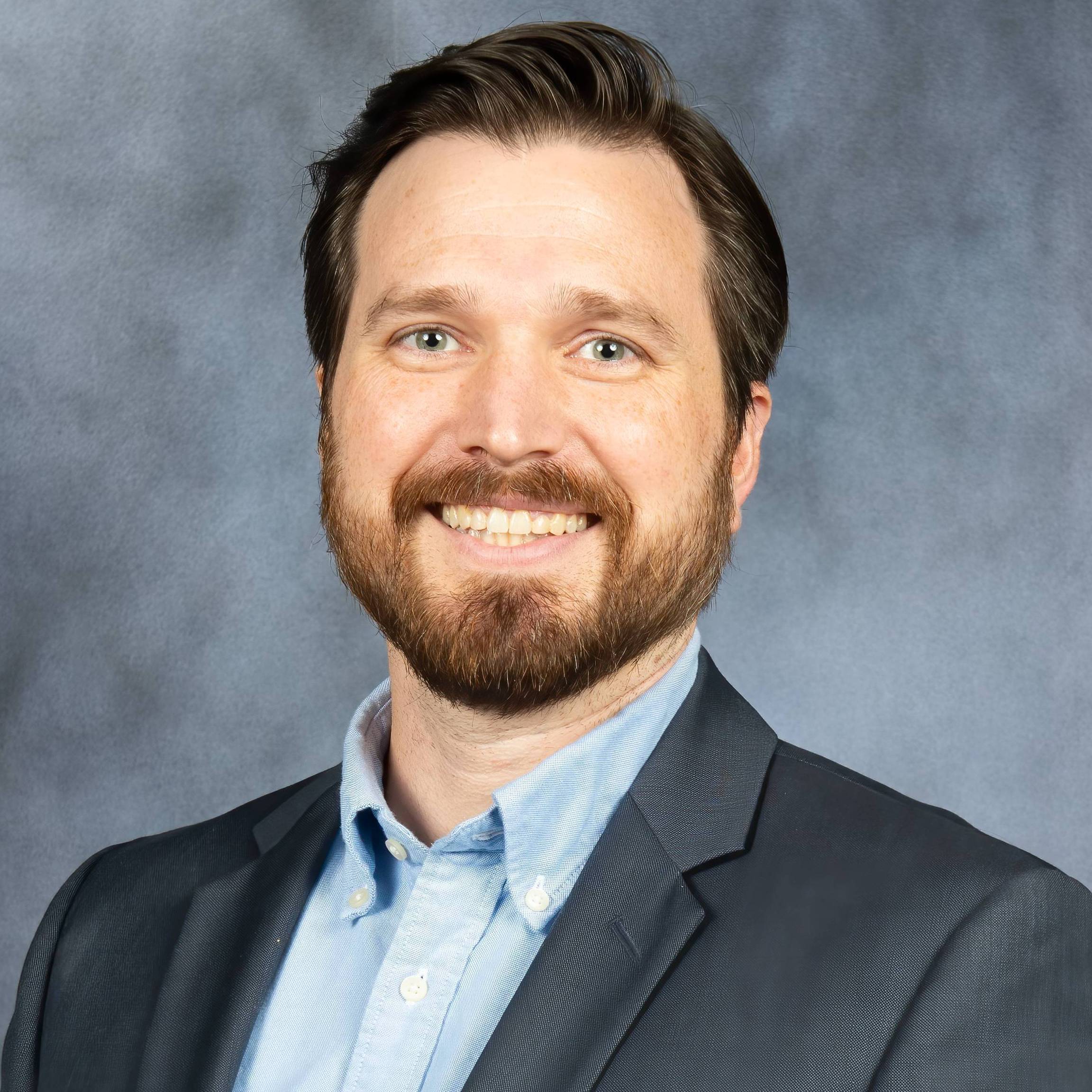 man smiling for headshot photo