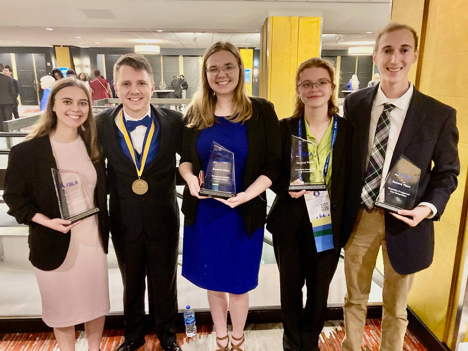 5 Students Holding Awards After Conference