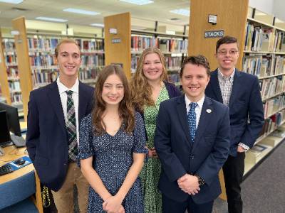 Group shot of male and female students in library representing club offices for student government association