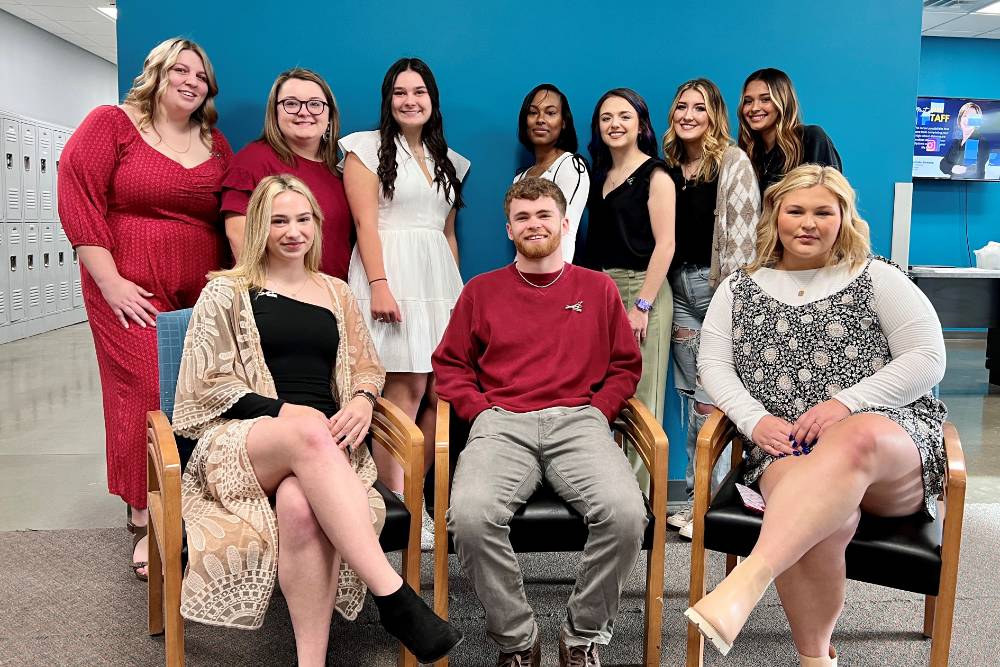 10 students who received pins for completing their cosmetology coursework