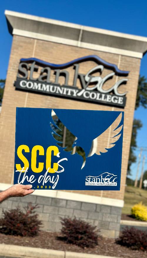 Sign with eagle cut out in front of Albemarle Main Campus entrance sign